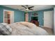 Main bedroom with teal walls and ensuite bathroom at 5791 Woodruff Way, Lakeland, FL 33812