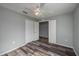 Gray bedroom with wood flooring and double doors at 5791 Woodruff Way, Lakeland, FL 33812