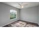 Bedroom featuring a large window, ceiling fan, and wood flooring at 5791 Woodruff Way, Lakeland, FL 33812