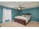 Main bedroom with teal walls and a large bed at 5791 Woodruff Way, Lakeland, FL 33812