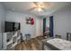 Bedroom with gray walls, wood flooring, and a ceiling fan at 5791 Woodruff Way, Lakeland, FL 33812