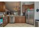 Spacious kitchen with stainless steel appliances and wood cabinets at 5791 Woodruff Way, Lakeland, FL 33812