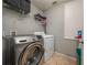 Bright laundry room with washer, dryer, and ample shelving at 5791 Woodruff Way, Lakeland, FL 33812