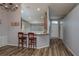 Open living room with hardwood floors and a breakfast bar at 5791 Woodruff Way, Lakeland, FL 33812
