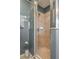 Walk-in shower with beige tile and glass enclosure at 5791 Woodruff Way, Lakeland, FL 33812