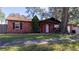 Brick house with a large front yard and driveway at 611 Limber Ln, Lakeland, FL 33810