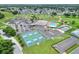 Aerial view of community with clubhouse, pool, and pickleball courts at 6243 Egret Dr, Lakeland, FL 33809