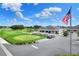 Community clubhouse with golf cart parking and American flag at 6243 Egret Dr, Lakeland, FL 33809