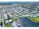 Aerial view showcasing home and community near lake at 6683 Briarhill Ne Dr, Winter Haven, FL 33881