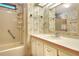 Bathroom with floral wallpaper, bathtub, and vanity at 6683 Briarhill Ne Dr, Winter Haven, FL 33881