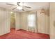 Bedroom with ceiling fan, closet, and carpet flooring at 6683 Briarhill Ne Dr, Winter Haven, FL 33881