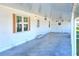 Covered patio with herringbone-pattern tile flooring at 6683 Briarhill Ne Dr, Winter Haven, FL 33881