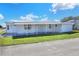 Front view of the white single-wide home at 6683 Briarhill Ne Dr, Winter Haven, FL 33881