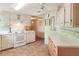 Kitchen with white cabinets, wood countertops, and tiled floor at 6683 Briarhill Ne Dr, Winter Haven, FL 33881