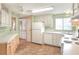White appliances and light wood cabinets in this kitchen at 6683 Briarhill Ne Dr, Winter Haven, FL 33881