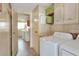Laundry room with washer, dryer, and access to kitchen at 6683 Briarhill Ne Dr, Winter Haven, FL 33881