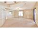Bright living room featuring carpeted floor and large windows at 6683 Briarhill Ne Dr, Winter Haven, FL 33881