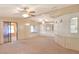 Spacious living room with carpeted floor and ceiling fans at 6683 Briarhill Ne Dr, Winter Haven, FL 33881