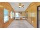 Sunroom with wood paneling, built in shelving, and window at 6683 Briarhill Ne Dr, Winter Haven, FL 33881