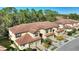 Aerial view of a row of townhouses featuring Spanish-style architecture and a tree-lined setting at 8205 Roseville, Davenport, FL 33896