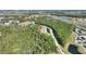 Aerial view of home nestled in a wooded area near a roadway at 8205 Roseville, Davenport, FL 33896