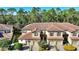 Aerial view of townhouses with tile roofs, two-car garages, and lush landscaping at 8205 Roseville, Davenport, FL 33896