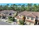 Aerial view showcasing a row of townhouses with terracotta roofs and tree-lined streets at 8205 Roseville, Davenport, FL 33896