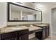 Double vanity bathroom with granite countertops and large mirror at 8205 Roseville, Davenport, FL 33896