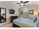 Bright bedroom with a queen bed, TV, and plenty of natural light at 8205 Roseville, Davenport, FL 33896