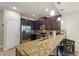 Kitchen features granite countertops, dark wood cabinets, and stainless steel appliances at 8205 Roseville, Davenport, FL 33896