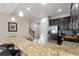 Open kitchen with granite counters, stainless steel appliances and breakfast bar at 8205 Roseville, Davenport, FL 33896