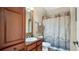 Well-appointed bathroom with wood vanity and shower/tub combo at 904 Charo Pkwy # 517, Davenport, FL 33897