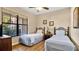 Charming bedroom featuring two twin beds and a large window at 904 Charo Pkwy # 517, Davenport, FL 33897