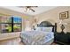 King-size bedroom with wood flooring and access to a patio at 904 Charo Pkwy # 517, Davenport, FL 33897