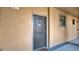 Inviting condo entryway with a dark gray door and neutral colored walls at 904 Charo Pkwy # 517, Davenport, FL 33897