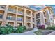 Inviting condo building with stone accents and lush landscaping at 904 Charo Pkwy # 517, Davenport, FL 33897