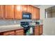 Modern kitchen featuring granite countertops and ample wood cabinets at 904 Charo Pkwy # 517, Davenport, FL 33897