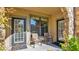 Spacious patio with double doors, two chairs, and side yard access at 904 Charo Pkwy # 517, Davenport, FL 33897