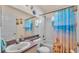Bathroom with tub, shower, and beach-themed decor at 7525 Jessamine Dr, Lakeland, FL 33810