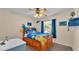 Bright bedroom with a wooden bed frame and ocean-themed bedding at 7525 Jessamine Dr, Lakeland, FL 33810