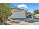 House exterior featuring a two-car garage and well-maintained landscaping at 7525 Jessamine Dr, Lakeland, FL 33810
