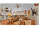 Living room with sectional sofa, wood floors and view into kitchen at 7525 Jessamine Dr, Lakeland, FL 33810