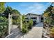 Welcoming entrance with a white pergola and lush garden at 1323 Valley E Hl, Lakeland, FL 33813