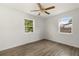 Well-lit bedroom with hardwood floors, two windows and ceiling fan at 2473 Barbarossa, Deltona, FL 32738