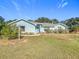 Ranch-style home with light blue exterior and a well-maintained lawn at 309 W Frederick Ave, Dundee, FL 33838