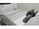 Secondary bedroom with a bed, dresser, and soft window treatments at 313 Wharf Way, Winter Haven, FL 33881