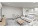 Open living room featuring a comfy sofa, armchair, and coffee table at 313 Wharf Way, Winter Haven, FL 33881