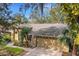 Tan house with mature landscaping and two-car garage at 3845 Garnet Dr, Mulberry, FL 33860