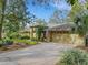 Exterior of a tan house with a two-car garage and landscaping at 3845 Garnet Dr, Mulberry, FL 33860