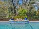 Relaxing pool area with lush landscaping and a tiled deck at 3845 Garnet Dr, Mulberry, FL 33860